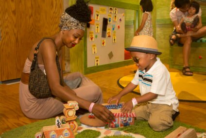 A mom and son enjoying imaginative play together at the Daniel Tiger’s Neighborhood Exhibit, exploring the fun activities at Boston Children’s Museum.