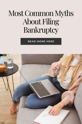 Young woman sitting on a couch with a laptop, notebook, and glasses, researching common myths about filing bankruptcy, emphasizing financial literacy and legal education