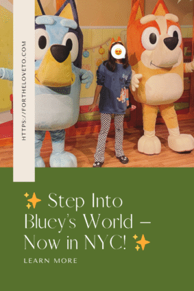 Young girl posing with life-sized Bluey and Bingo mascots at the Bluey x CAMP experience in New York City.