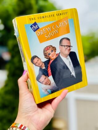 The Drew Carey Show: The Complete Series DVD box set featuring cast members Drew Carey, Mimi, Ryan Stiles, and others on a bright yellow package design.