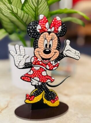 Diamond Art Club Disney Minnie Mouse standee in progress with colorful resin diamonds and applicator tools on table