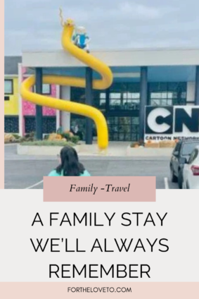 Exterior of the Cartoon Network Hotel in Lancaster, PA with the iconic yellow slide and CN sign during a family visit near Dutch Wonderland