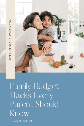 Mom hugging toddler in the kitchen with toys and snacks on the counter — family budget hacks and smart money tips for new parents.