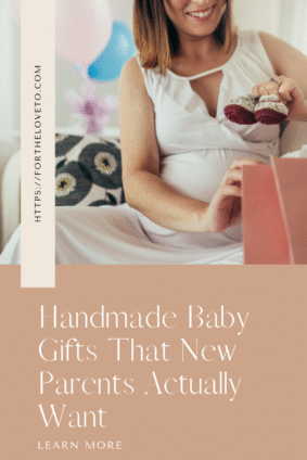 Smiling pregnant woman holding a pair of handmade baby booties during a baby shower, with pastel balloons in the background. Text overlay reads “Handmade Baby Gifts That New Parents Actually Want – fortheloveto.com.