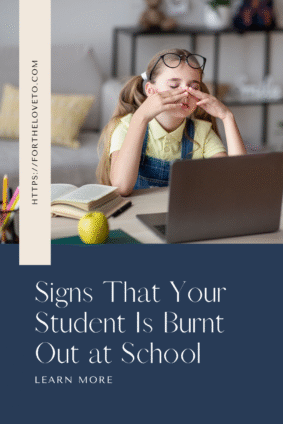 Exhausted student rubbing her eyes while studying at home with books and a laptop, representing signs of student burnt out at school