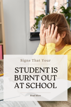 Stressed young student covering her face with her hands while studying, illustrating emotional overwhelm and student burnt out at school.