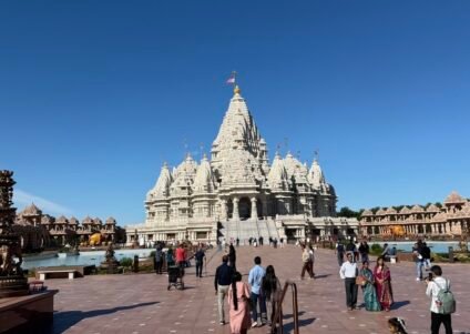 Front view of the white marble BAPS Shri Swaminarayan Mandir Robbinsville NJ with carved domes and shikharas.