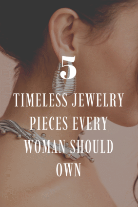 Side profile of a woman wearing silver statement earrings and a layered necklace with bold metallic textures. Text overlay reads “5 Timeless Jewelry Pieces Every Woman Should Own.” Elegant inspiration for modern, timeless accessories.