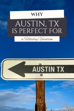 Directional road sign pointing toward Austin TX under a bright blue sky, promoting a family vacation in Austin TX for the holidays.