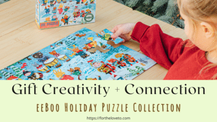 A young child in a red sweater pieces together eeBoo’s Yumi’s Winter Carols puzzle on a wooden table beside a box of holiday puzzles, symbolizing creativity, connection, and meaningful family time during the holidays.