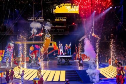 Performers from Ringling Bros. and Barnum & Bailey® The Greatest Show On Earth® on stage surrounded by fireworks and acrobats during the high-energy finale.