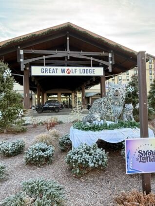 Great Wolf Lodge main entrance with winter decorations and wolf statue, welcoming families to an all-inclusive indoor water park resort.