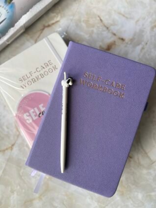 Planners With Purpose purple self-care workbook designed for mindfulness, reflection, and New Year goal setting.
