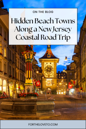 First time traveling to Europe wanderer’s guide featuring a historic European city street at night with clock tower and glowing lights