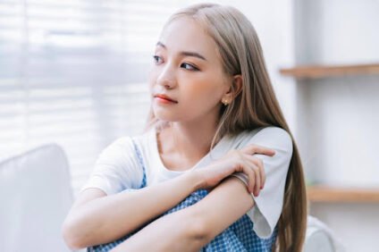 Teen experiencing burnout while sitting alone and showing signs of emotional exhaustion and chronic stress.
