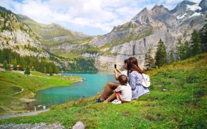 Spring family travel adventure with a parent and child enjoying a scenic mountain lake view together.