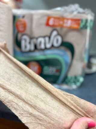 Testing the durability of Bravo eco-friendly paper towels with strong cloth-like texture for household cleanups.