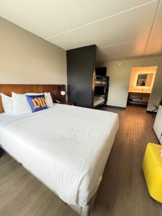 Freshly updated family guest room at the Dutch Wonderland Inn with a king bed, bunk beds, and modern finishes after the rebrand.