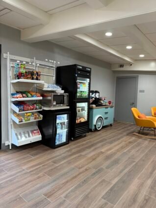 Snack market, coffee station, and grab-and-go refreshments in the lobby of Spark by Hilton Lake George Outlets during our family stay.