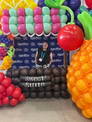 Entrance display at the Sweet Suite toy event in New York City featuring colorful event decorations.