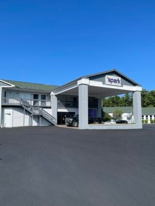 Exterior of Spark by Hilton Lake George Outlets, featured in this Spark by Hilton Lake George Outlets Review, showcasing the hotel's updated entrance and convenient location near Lake George.