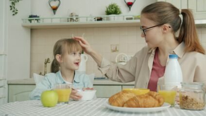 Mom and daughter eating breakfast as part of their back to school routine for kids