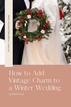 Bride and groom holding an evergreen wreath with red berries and white cotton accents, with text reading “How to Add Vintage Charm to a Winter Wedding.”